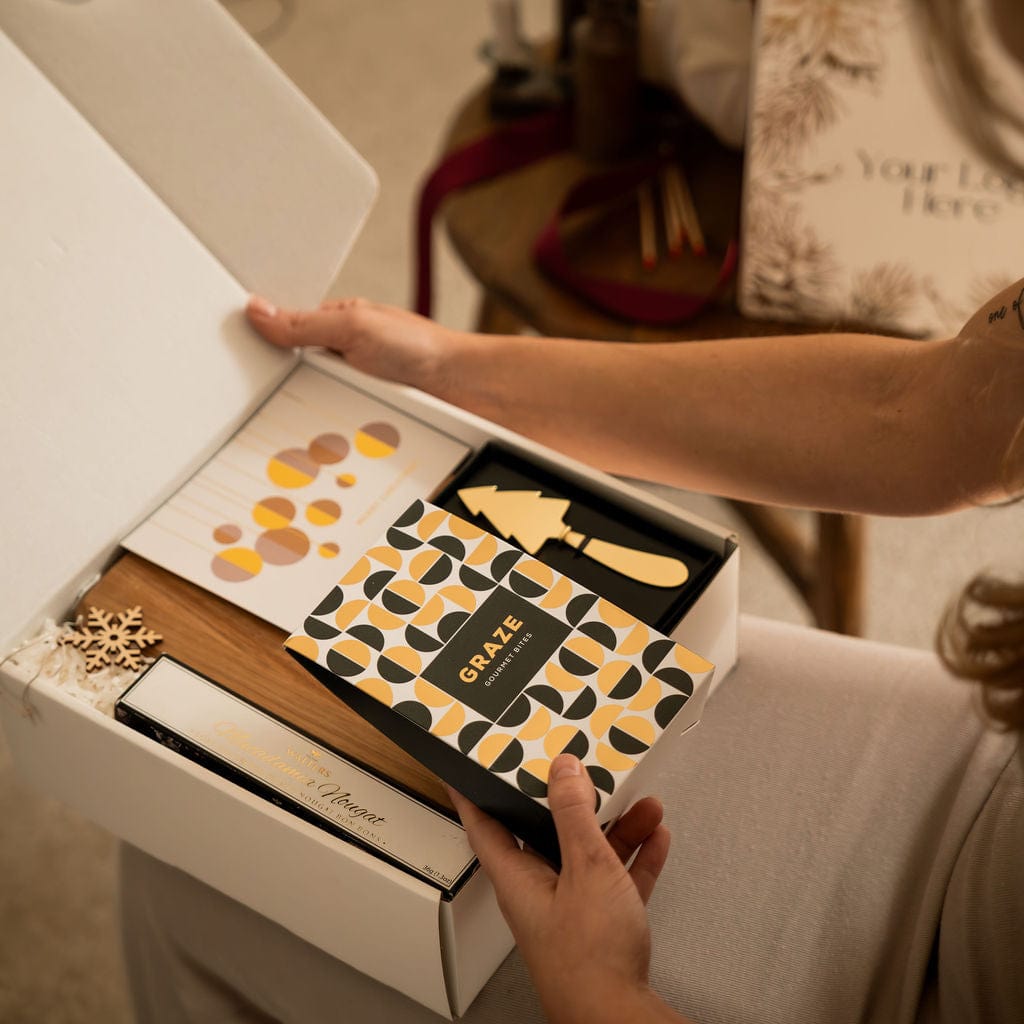 woman opening gold christmas gift