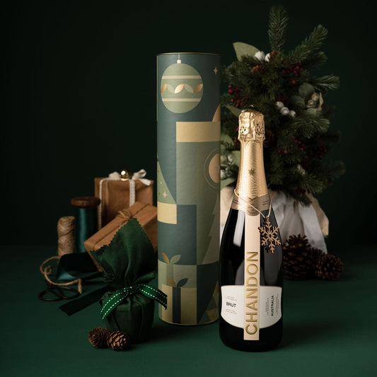 green themed christmas gift with champagne in cylinder packaging 