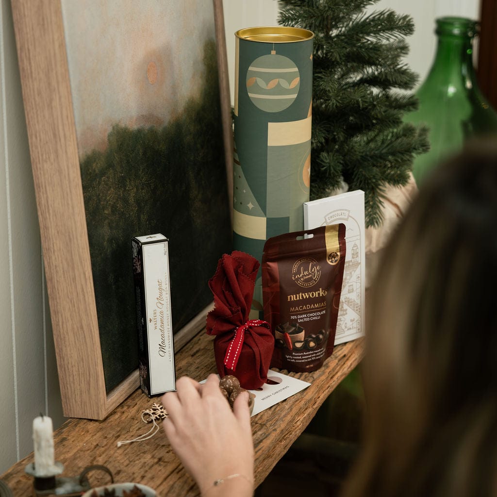 woman reaching for chocolate in christmas gift