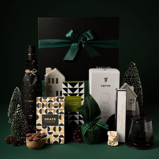 black christmas gift box with green ribbon and contents on display