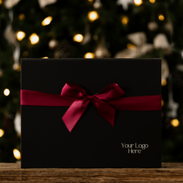 black gift box with red ribbon against background of lights