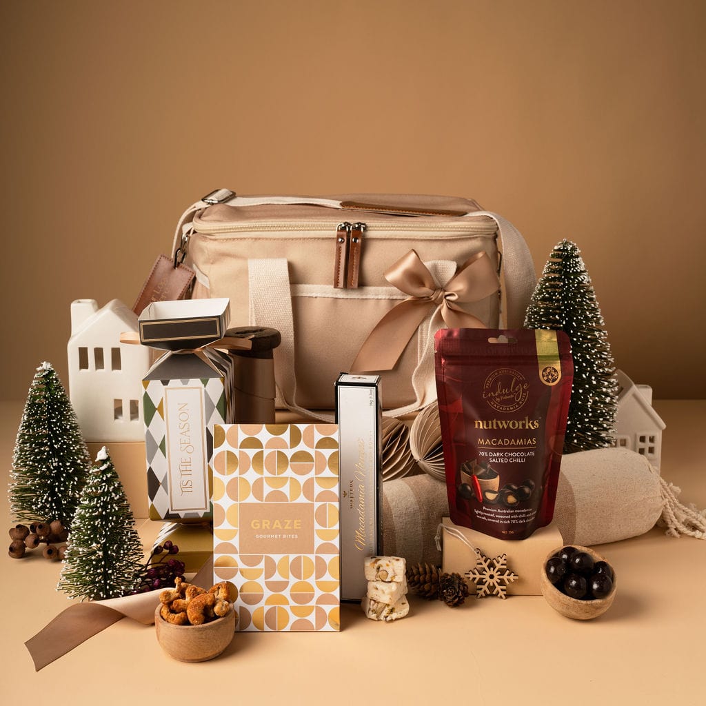 gold themed christmas gift with chocolate and bon bon displayed outside taupe cooler bag 