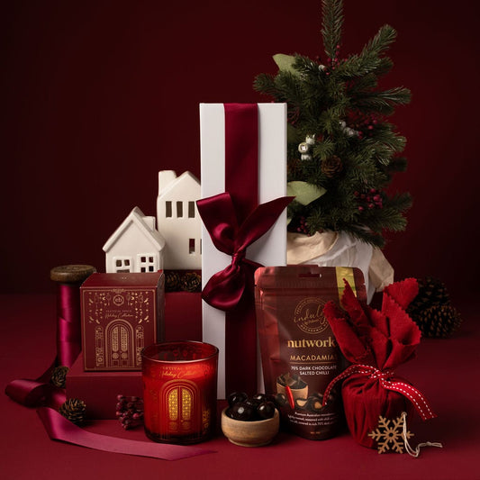 red themed christmas gift contents outside wine box packaging with chocolate, candle and pudding 