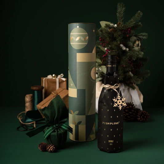 green themed christmas gift with alcohol and pudding in cylinder packaging