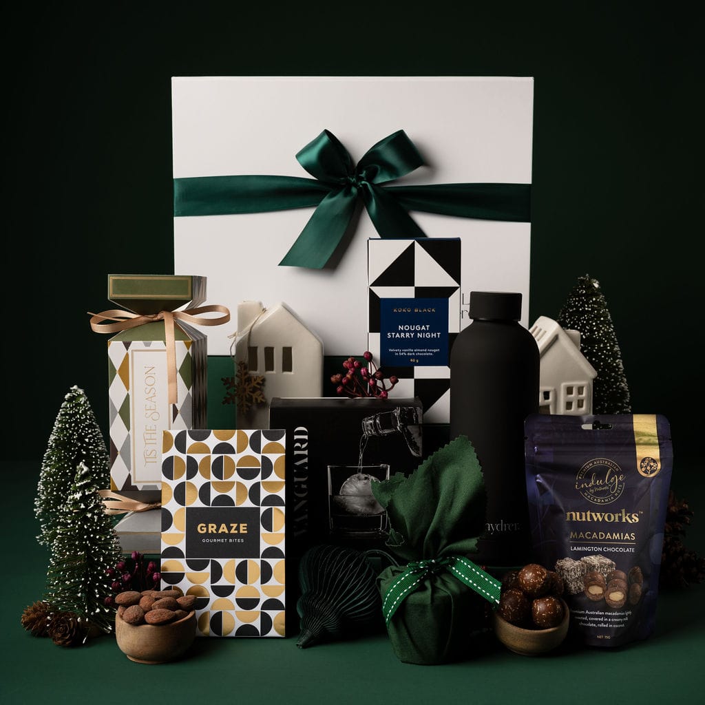 green themed christmas gift with contents on display against black background