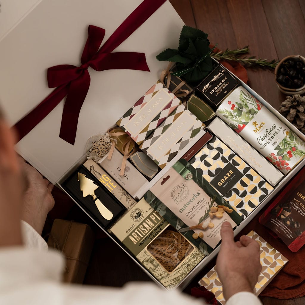 man opening gift box to show contents 